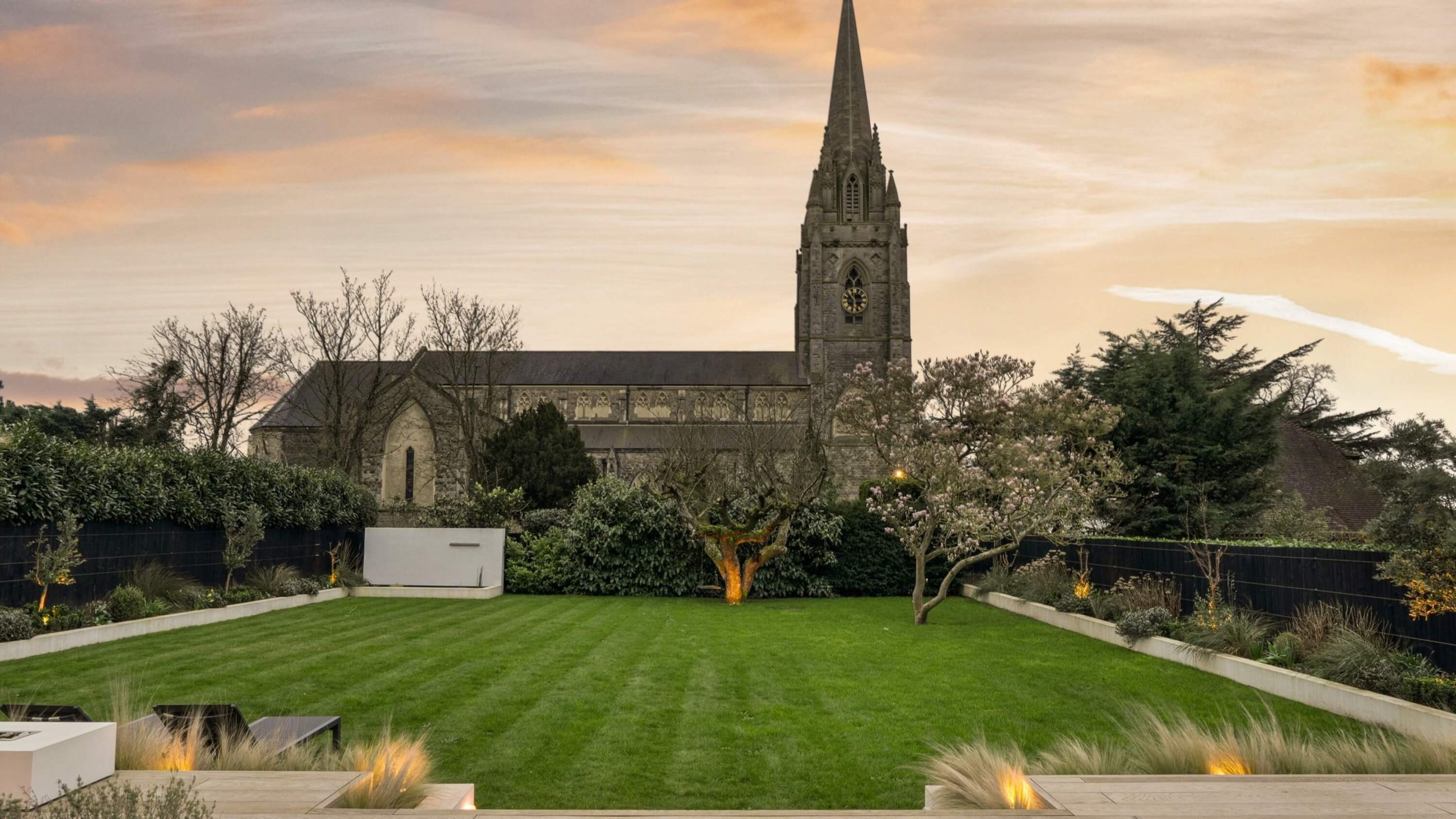 Twilight photography of garden overlooking a church of new build home London