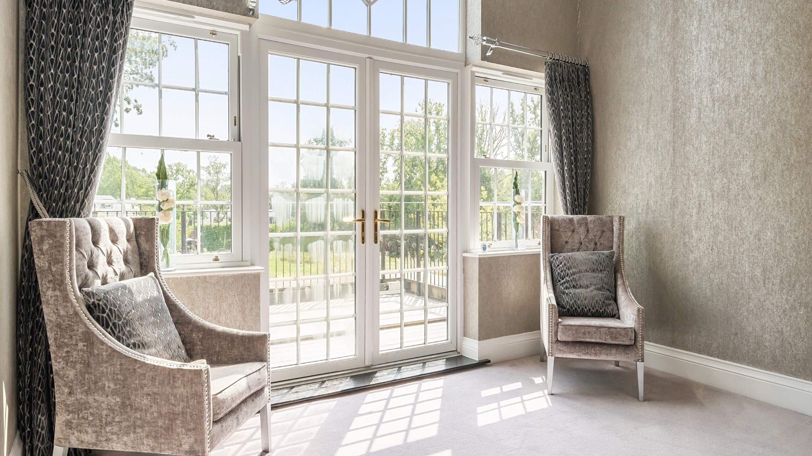 internal property photograph of sitting room overlooking grounds of luxury home