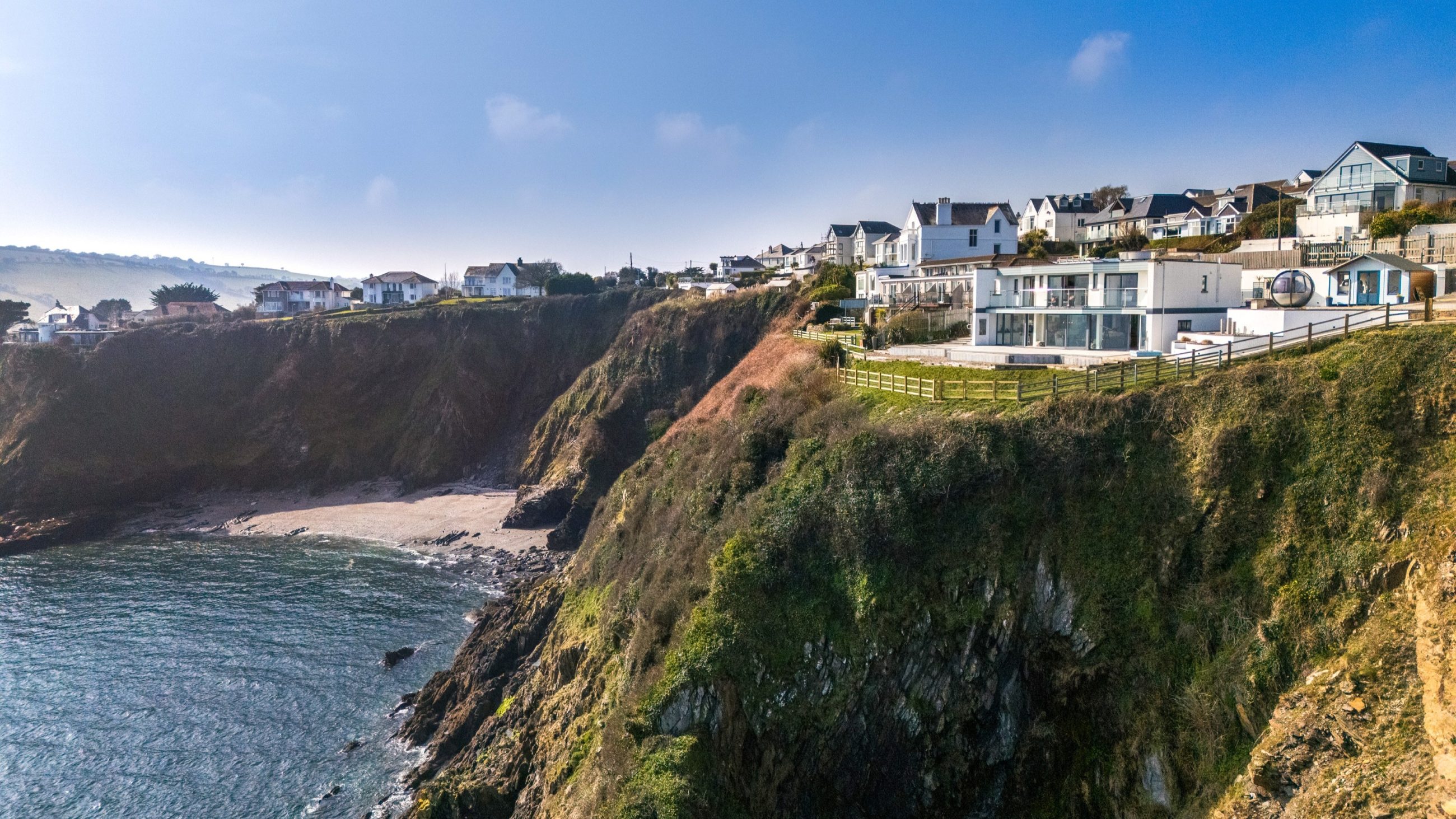 Drone perspective of Cornwall property perched on a cliff top
